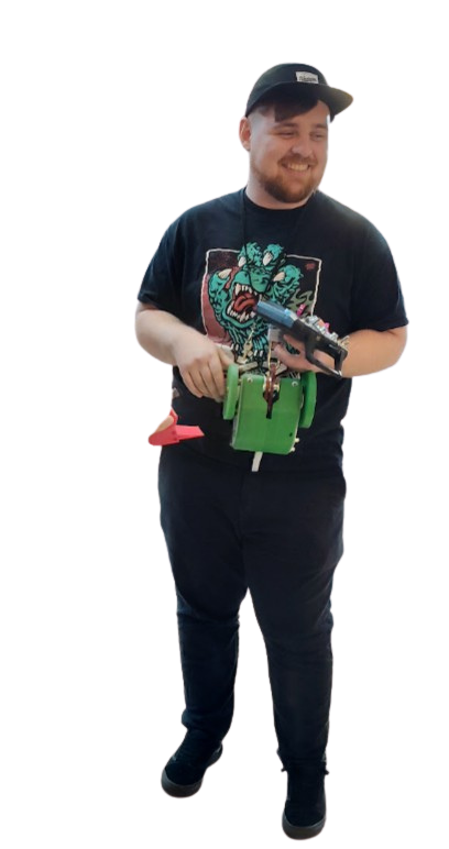 Clinton Parker, Senior Project Engineer at T&M Design, holding a BattleBot controller smiling with no background