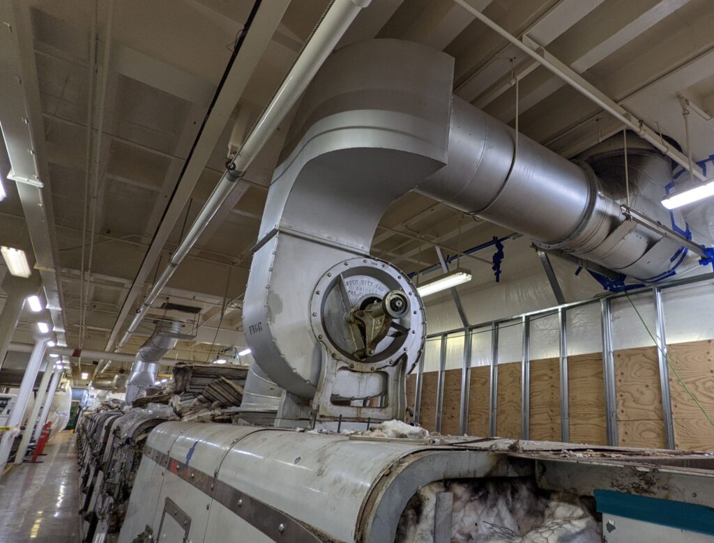 Commerical line of baking ovens in a food manufacturing facility, decommissioned before removal.