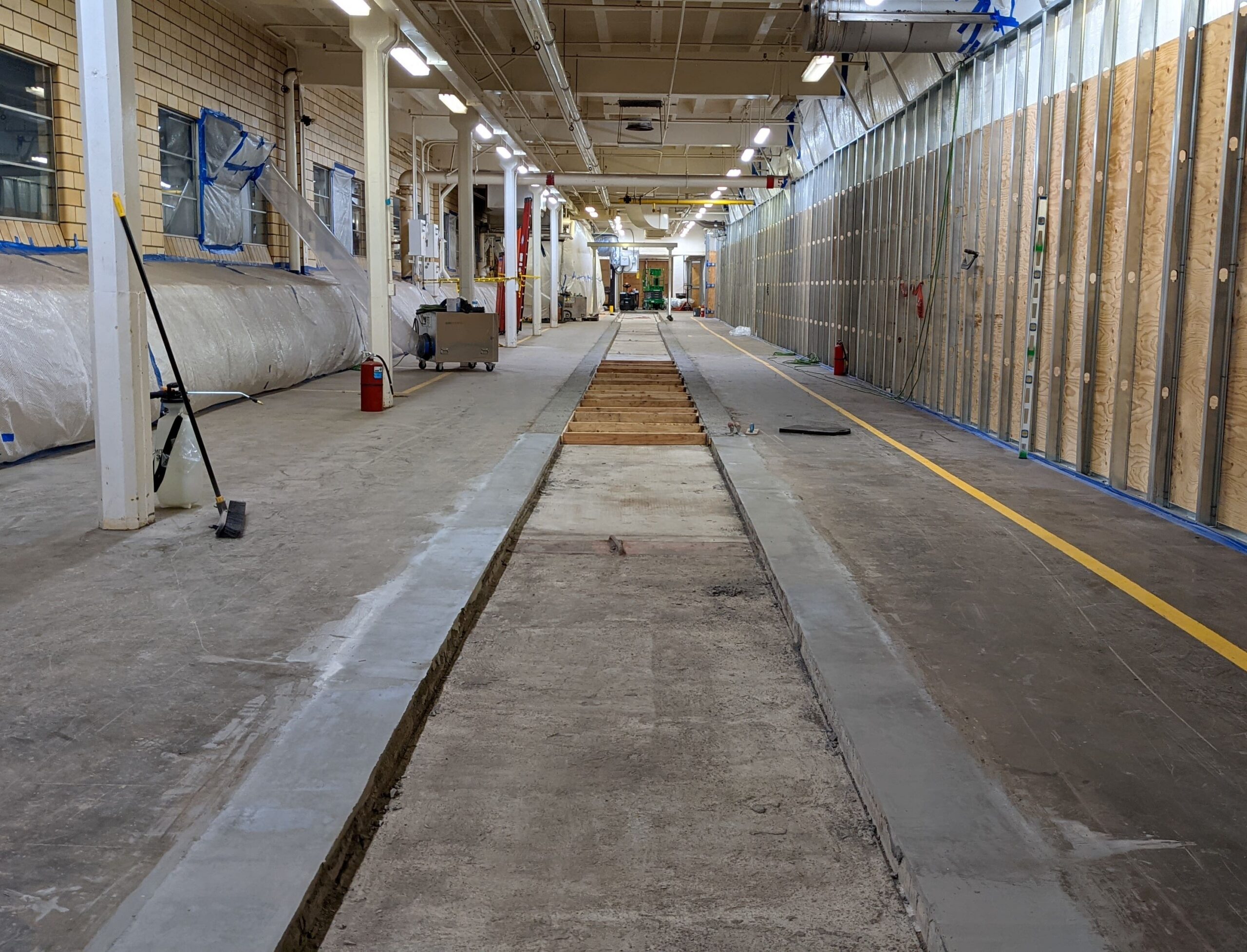 Demolition project mostly finished, with a clean floor and concrete laid down for new foundation